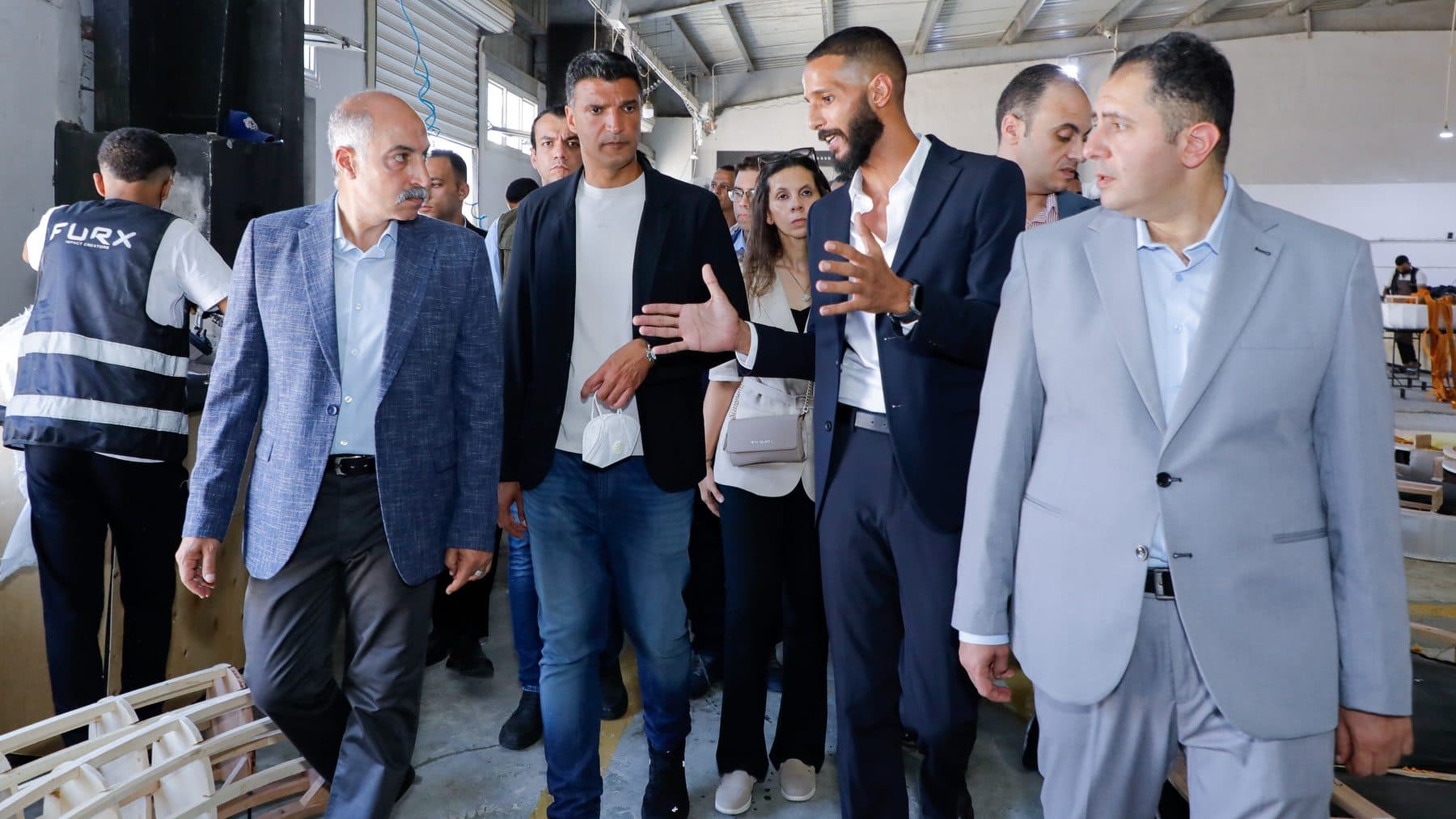 Minister Khaled Hashem, Governor Hossam El-Din Fawzy and FURX chairman Waleed El-Banna walk through the FURX upholstery line.